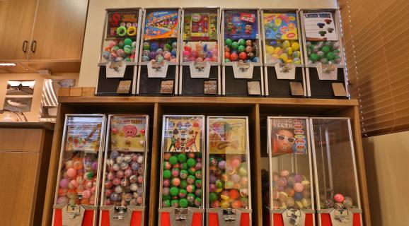 Colorful prize and gumball machines in the Southwest Pediatric Dentistry waiting area